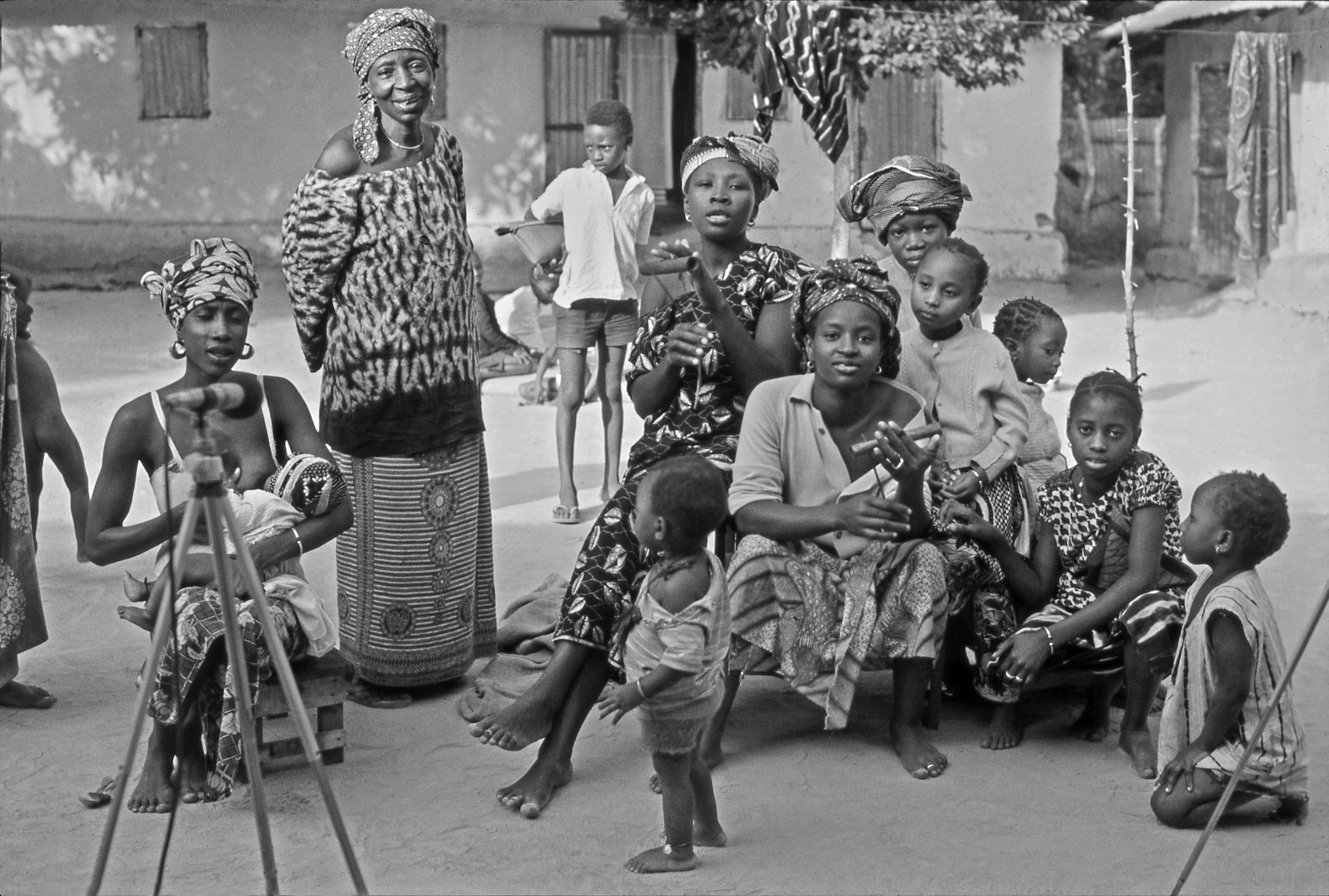 Yangkui_Kuiyate__center_left__and_Jabu_Sau__center_right__playing_iron_percussion_instruments__B_W_photo_by_Marc_Pevar